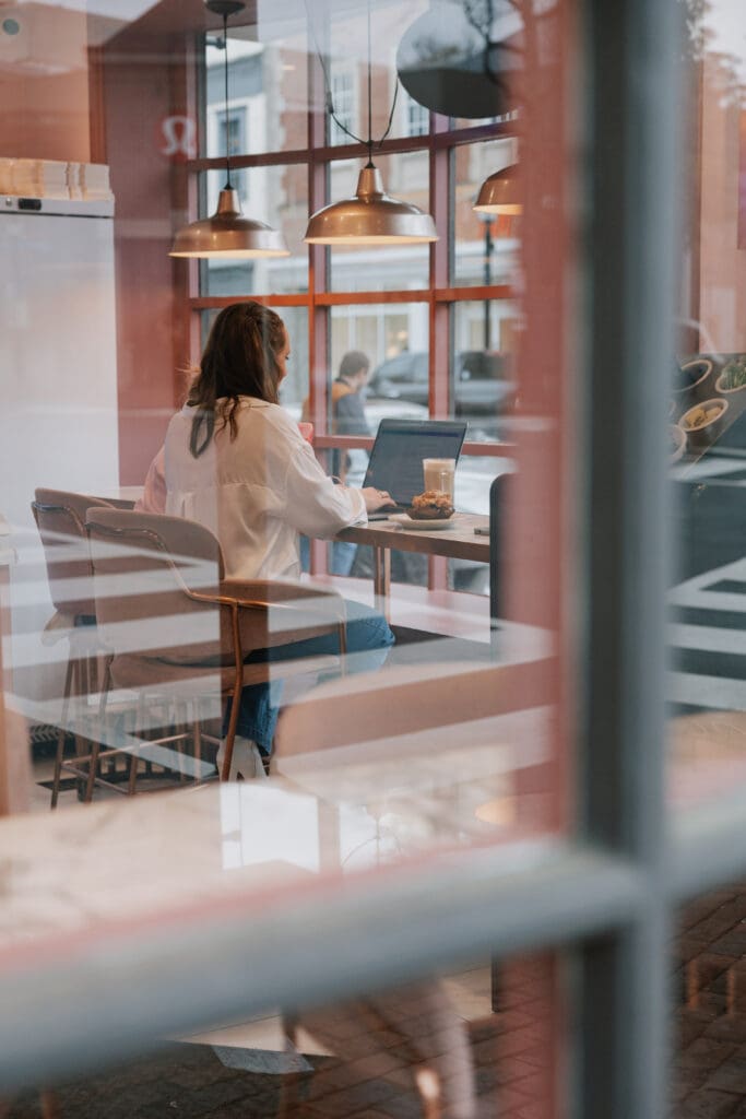 Ashley working remotely from a local coffee shop