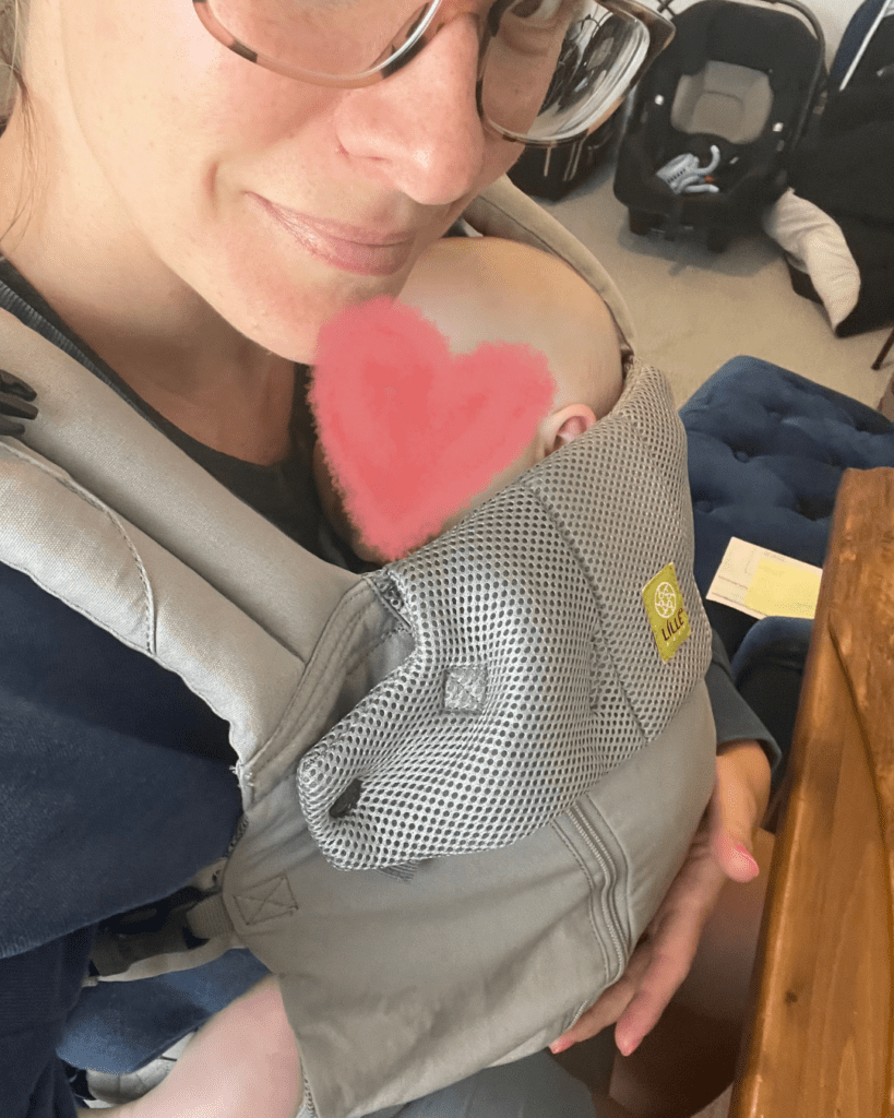 mom working with baby in carrier